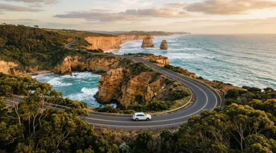 Australian coastal highway with rental car driving along scenic ocean road
