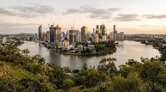 Brisbane modern cityscape with construction cranes and riverside development showcasing business growth opportunities