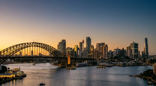 Sydney's iconic harbour skyline showcasing modern office towers framed by the Harbour Bridge at golden hour