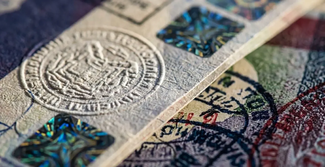 Macro shot of official documents with security features and stamps from multiple countries
