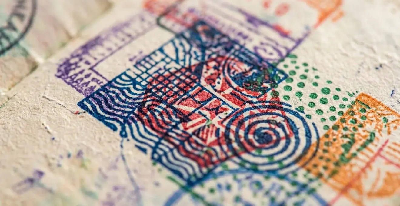 Macro shot of passport pages showing multiple entry stamps with selective focus