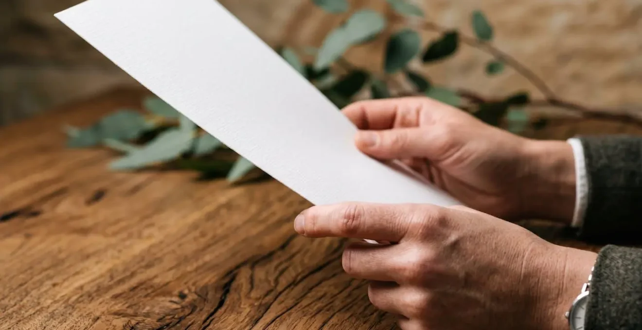 Close-up of hands reviewing a professional document on a clean Australian office desk